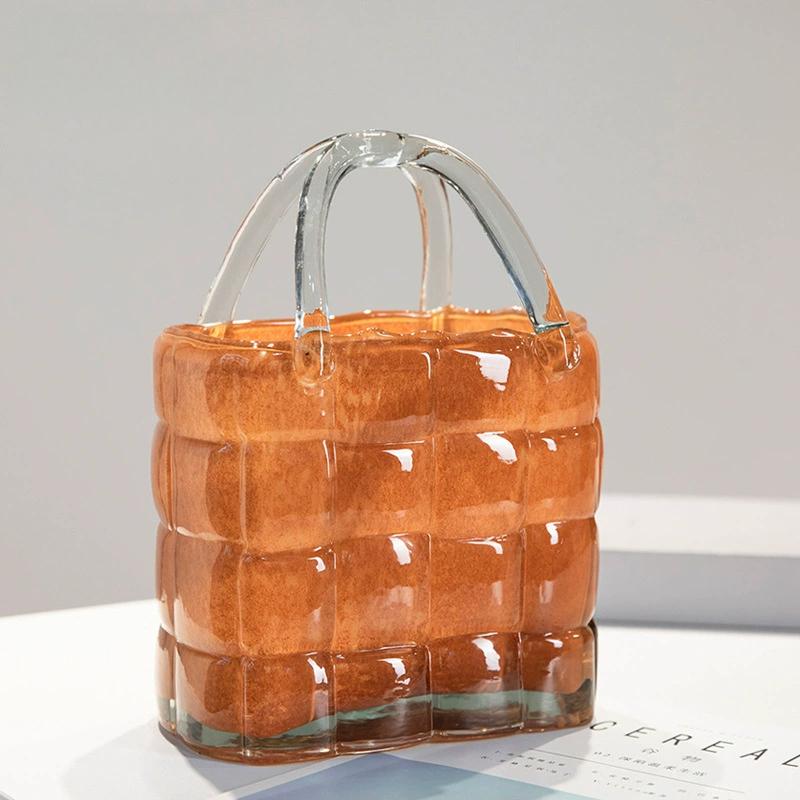 Close-up of amber handbag glass vase highlighting glossy finish and sturdy handle