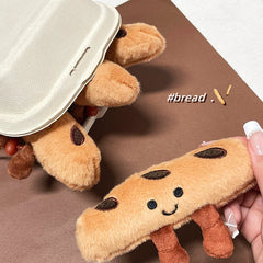 Baguette-shaped plush keychains partly inside a takeaway-style box, with #bread decoration