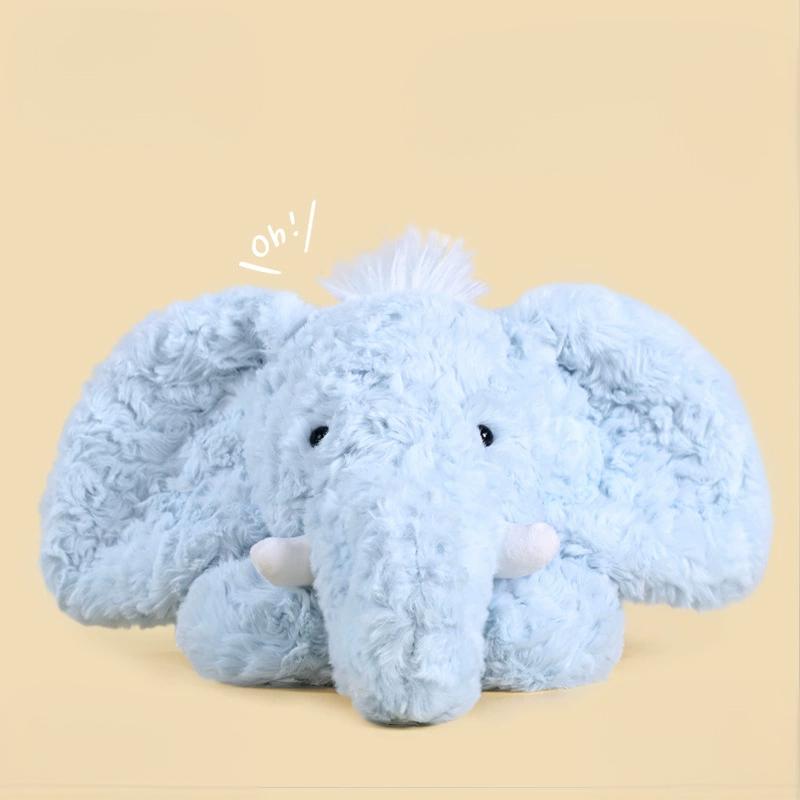 Soft blue elephant plush toy lying down, showcasing fluffy texture and playful ears