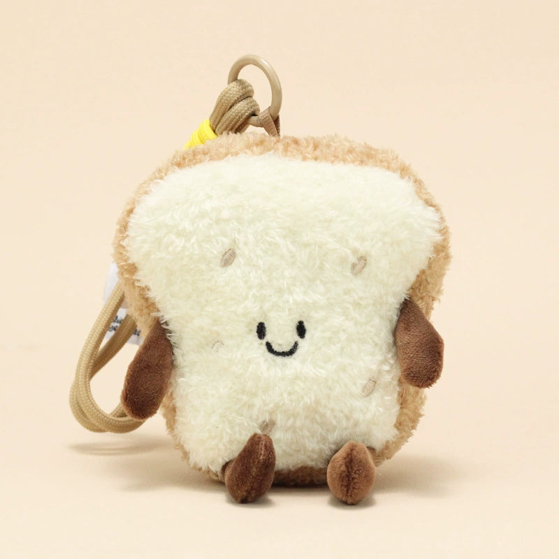 Side view of bread slice plush keychain with smiling face and brown limbs