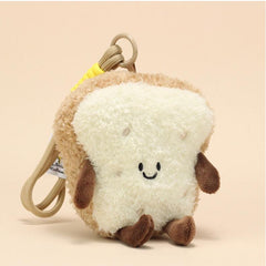 Front view of bread slice plush keychain with embroidered smiling face