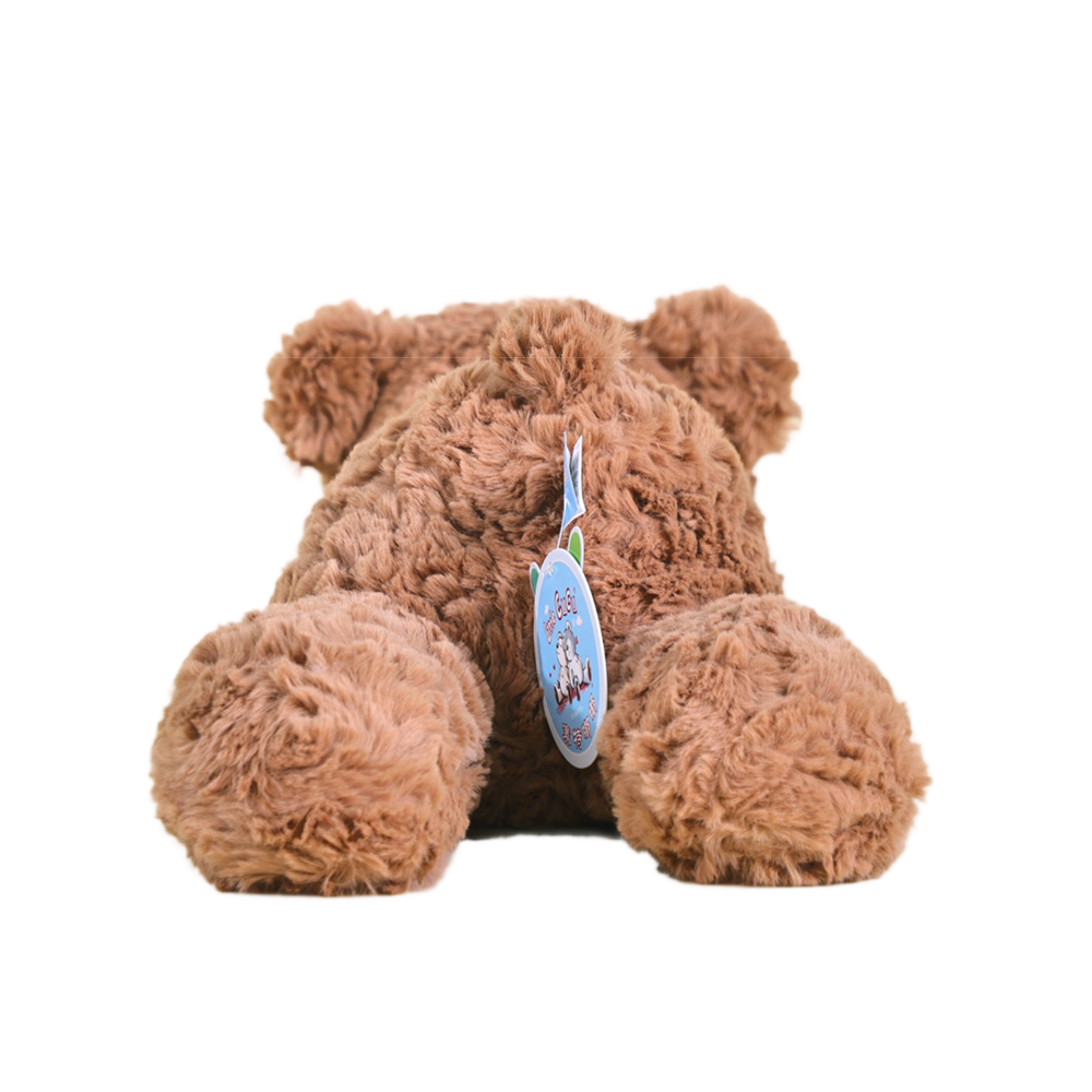  Back view showing plush material and safety tag of brown teddy bear