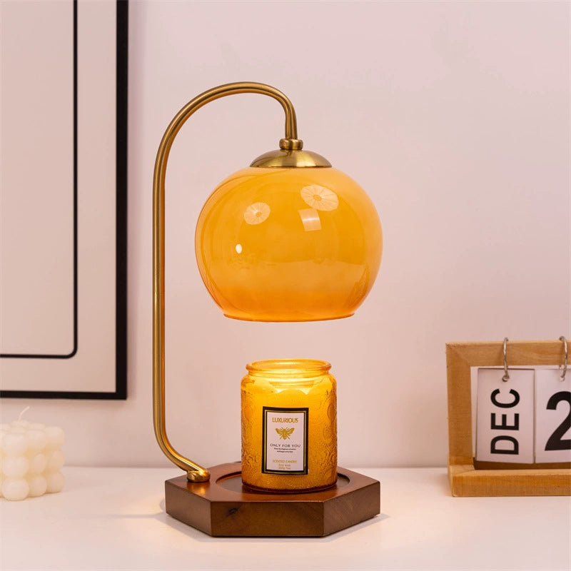 Vintage candle warmer lamp with candle on a classic styled table display