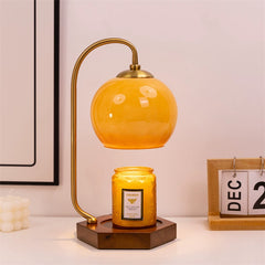 Vintage candle warmer lamp with candle on a classic styled table display