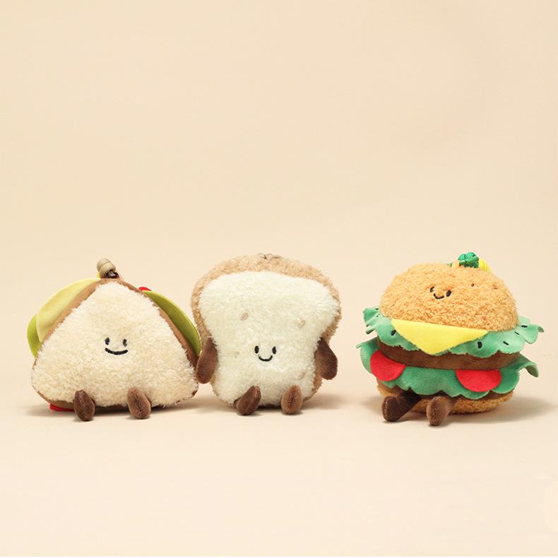 Close-up of sandwich, bread slice, and burger plush keychains highlighting their embroidered faces