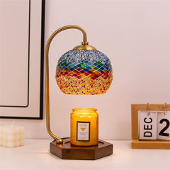 Scene of vintage candle warmer lamp with colorful mosaic glass shade, illuminating and uplifting the decor