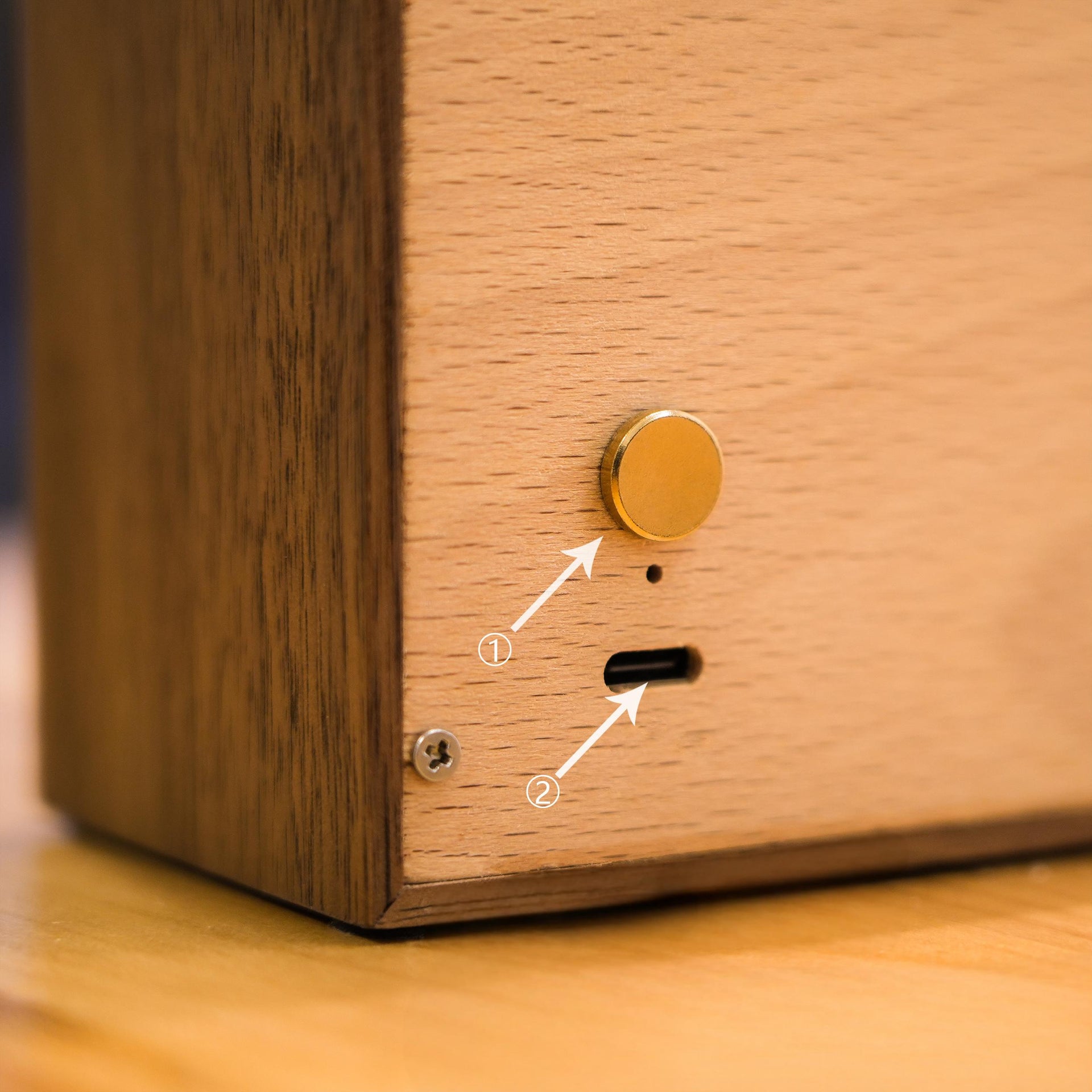 Macro view of the night light’s gold touch switch and USB charging port, showing elegant and modern design features.