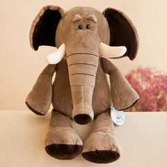 Large elephant plush toy sitting on a sofa, offering a soft, supportive presence for enhanced emotional connection through Plush Toys