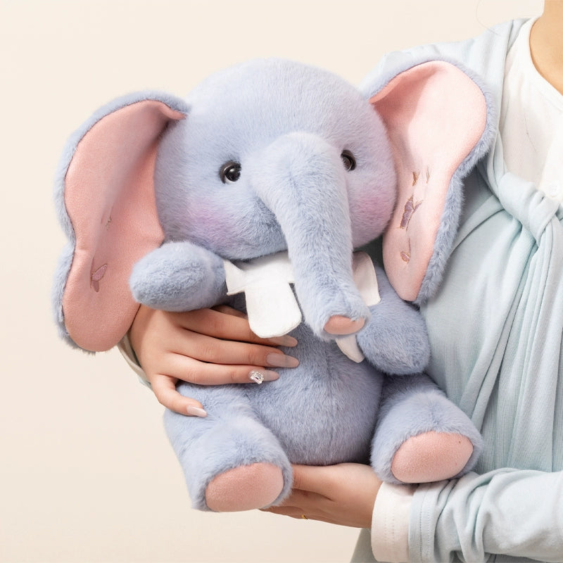 Blue elephant plush toy being gently held, showing size and plush comfort