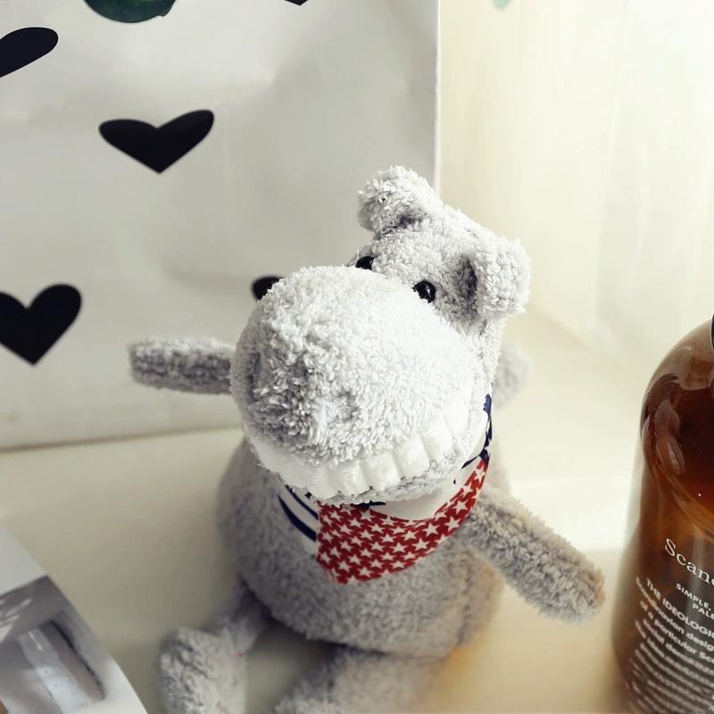 Soft grey hippo plush toy, smiling widely with a red star-patterned scarf, close-up view