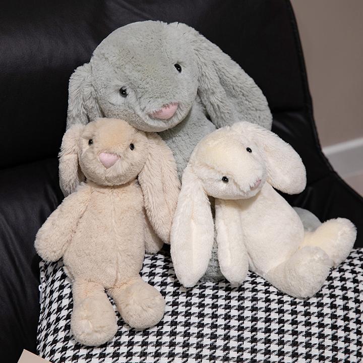 Plush lop-eared bunny toys of different sizes sitting together, perfect for diverse emotional needs.