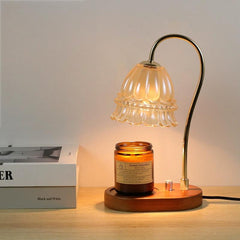 Candle warmer lamp with amber jar candle and book stack, ideal for creating a serene, inspirational reading corner