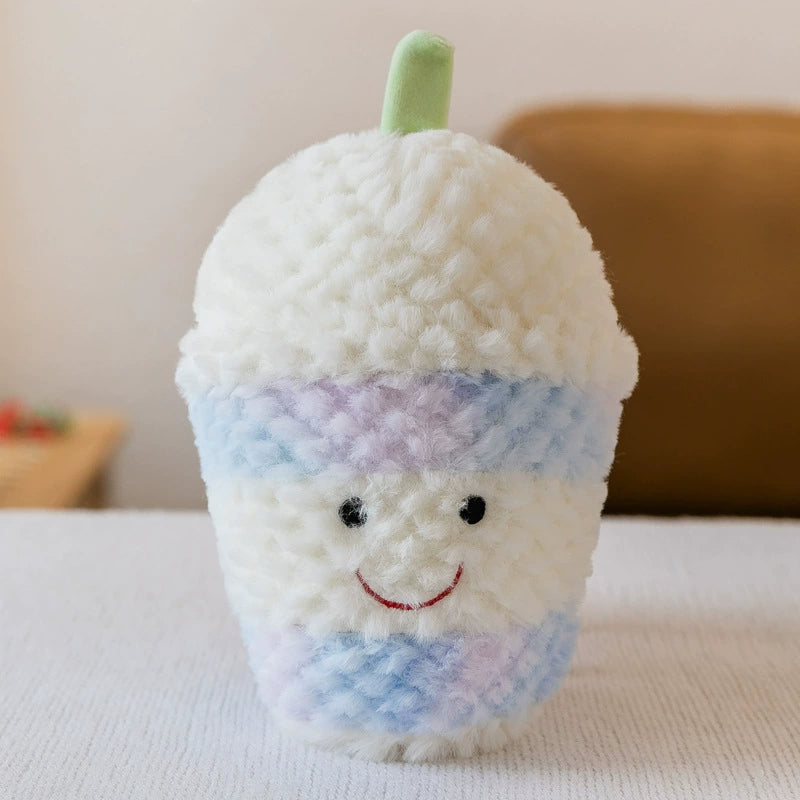 Plush toy shaped like a milk cup in pastel blue and white with a green straw