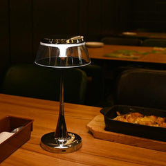 The lamp enhancing a dining table’s atmosphere with its sleek and minimalist design in a restaurant setting.