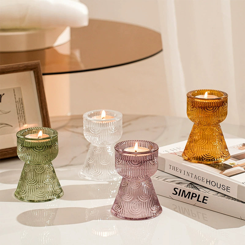 Set of colorful glass candle holders holding tealight candles, creating a cozy ambiance