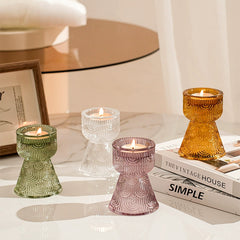 Set of colorful glass candle holders holding tealight candles, creating a cozy ambiance