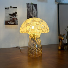 Mushroom-shaped glass desk lamp with vintage feel, softly illuminating a cozy space with a bear ornament.