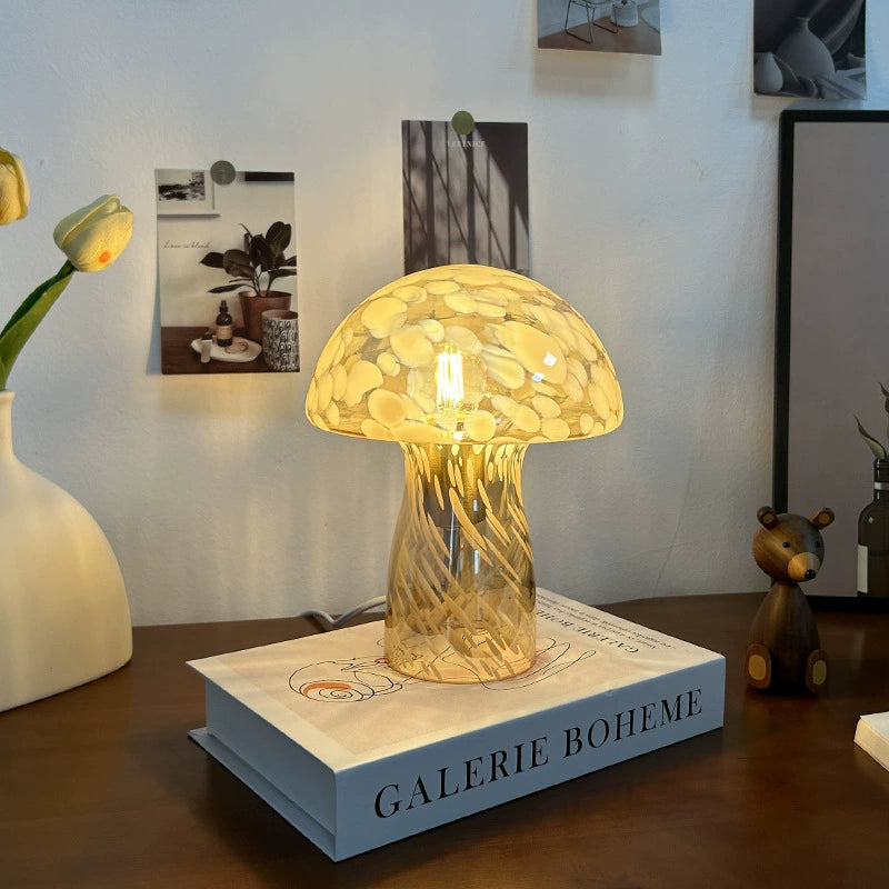 Vintage mushroom glass desk lamp placed on a book, enhancing the cozy reading atmosphere.
