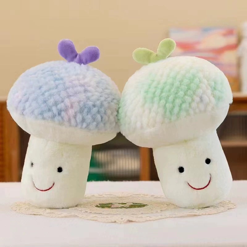 Set of two pastel-colored mushroom plush toys with smiling faces