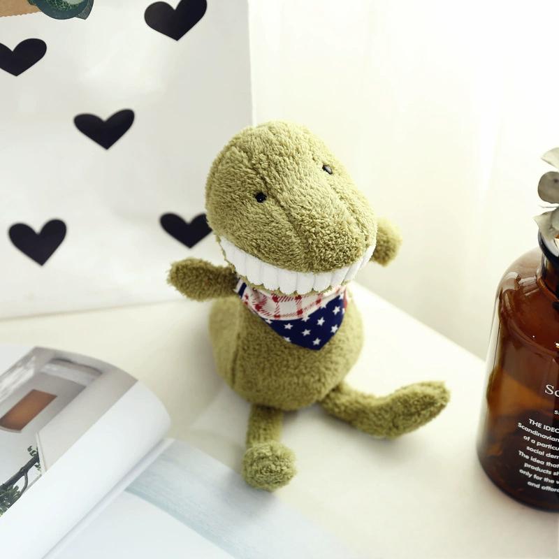 Olive green plush toy with big grin and patterned scarf, in warm home setting