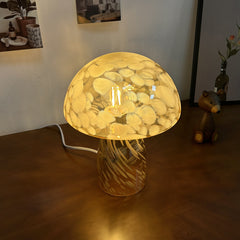 Overhead angle of mushroom glass desk lamp showing intricate retro glass texture and amber light.