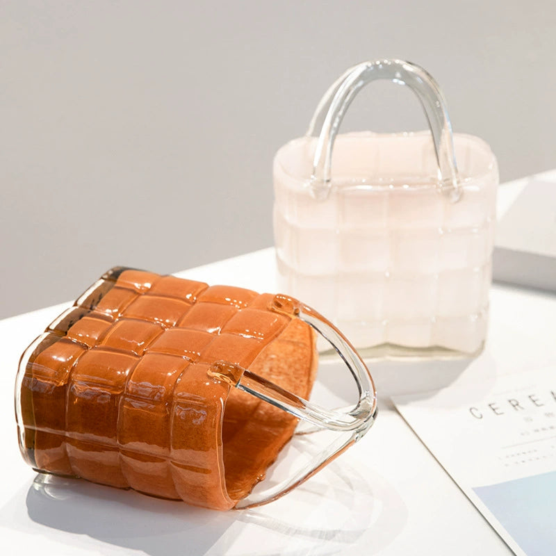 Two handbag style glass vases, one lying down and one upright, showing color options and basket texture
