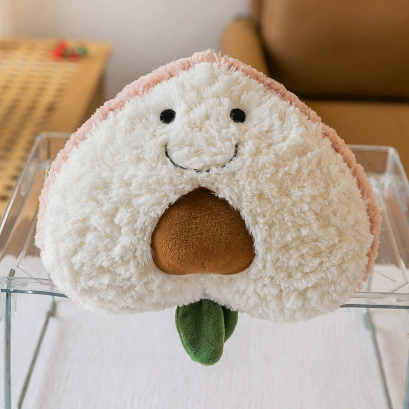 Peach plush toy designed as a half cut, showing a cute brown pit