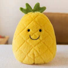 Cheerful pineapple plush toy with bright yellow short plush and green top, sitting on a table