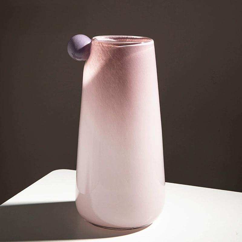 Elegant pink glass vase with a unique bubble accent, made with artisan blowing technique, blending chic design and soft warmth.