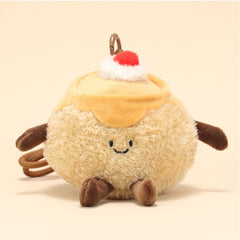 Front view of pudding plush keychain with happy expression and decorative cherry