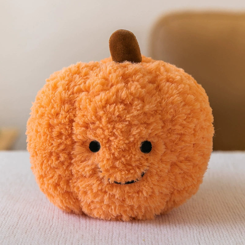 Round orange pumpkin plush toy with a brown stem and endearing smile