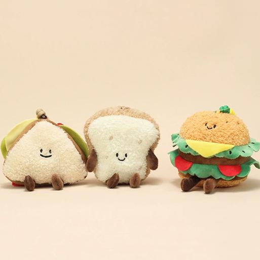 Three food plush keychains—sandwich, bread slice, and burger lined up side by side