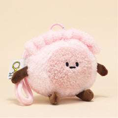 Side view of shrimp dumpling plush keychain with soft pink shell and brown limbs