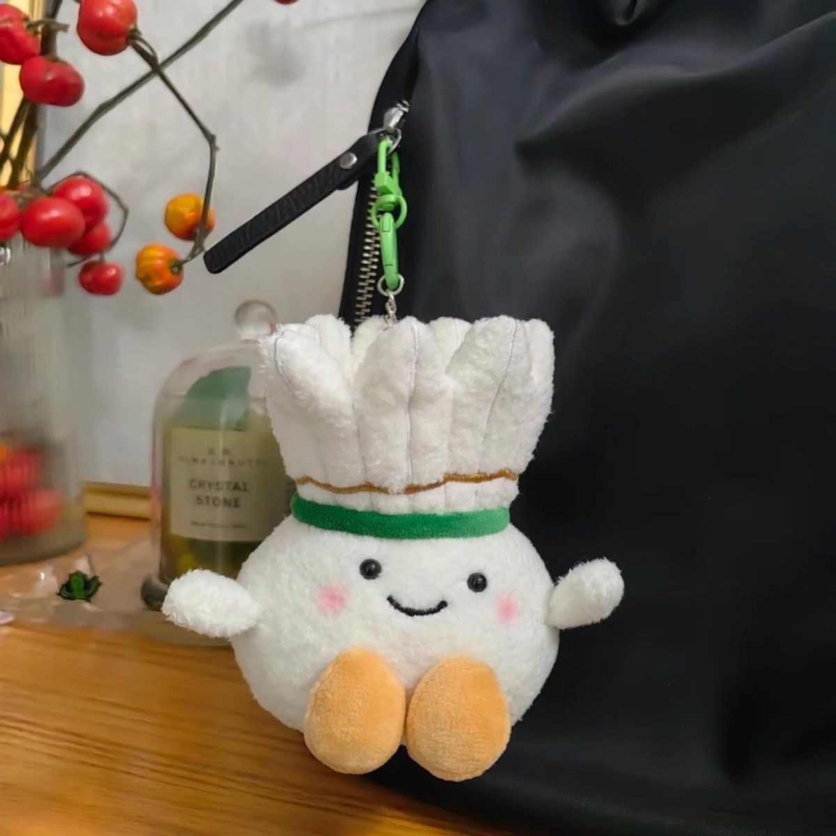 Shuttlecock plush keychain attached to a black backpack, adding a playful and gentle accent to the look.