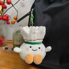 Shuttlecock plush keychain attached to a black backpack, adding a playful and gentle accent to the look.