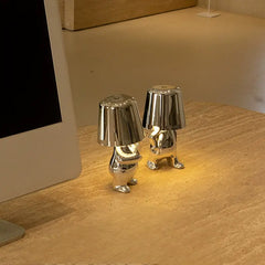 Silver and gold Soulster Lamps on a desk, providing modern comfort for daily routines