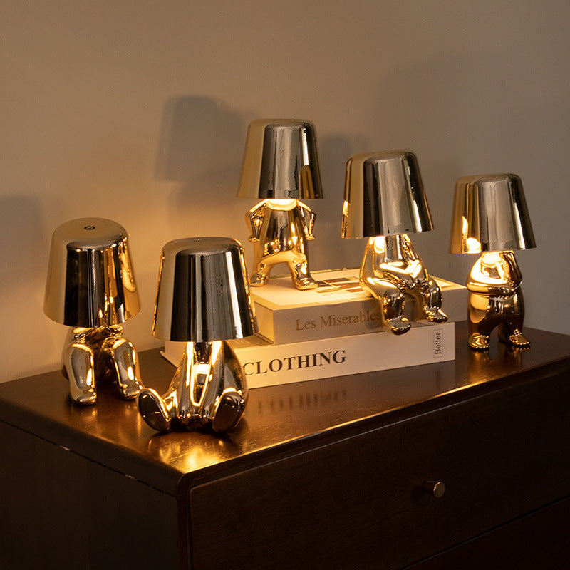 Assorted Soulster Lamps in gold and silver arranged on tabletop, evoking warmth and emotional comfort