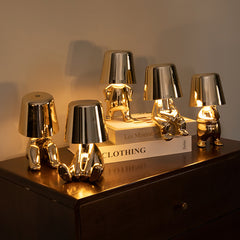 Assorted Soulster Lamps in gold and silver arranged on tabletop, evoking warmth and emotional comfort