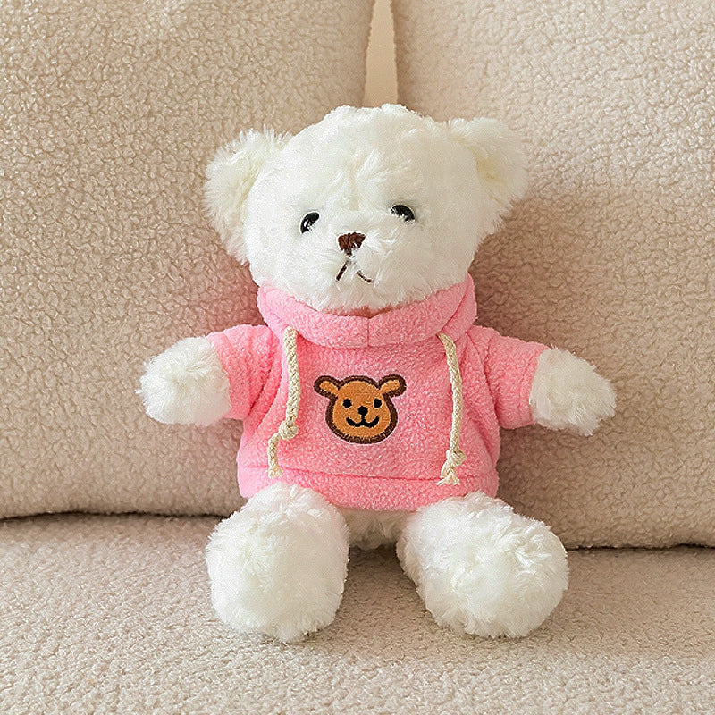 White Teddy Bear Plush wearing a pink hoodie, sitting on a beige sofa, SundayHue Plush Toys