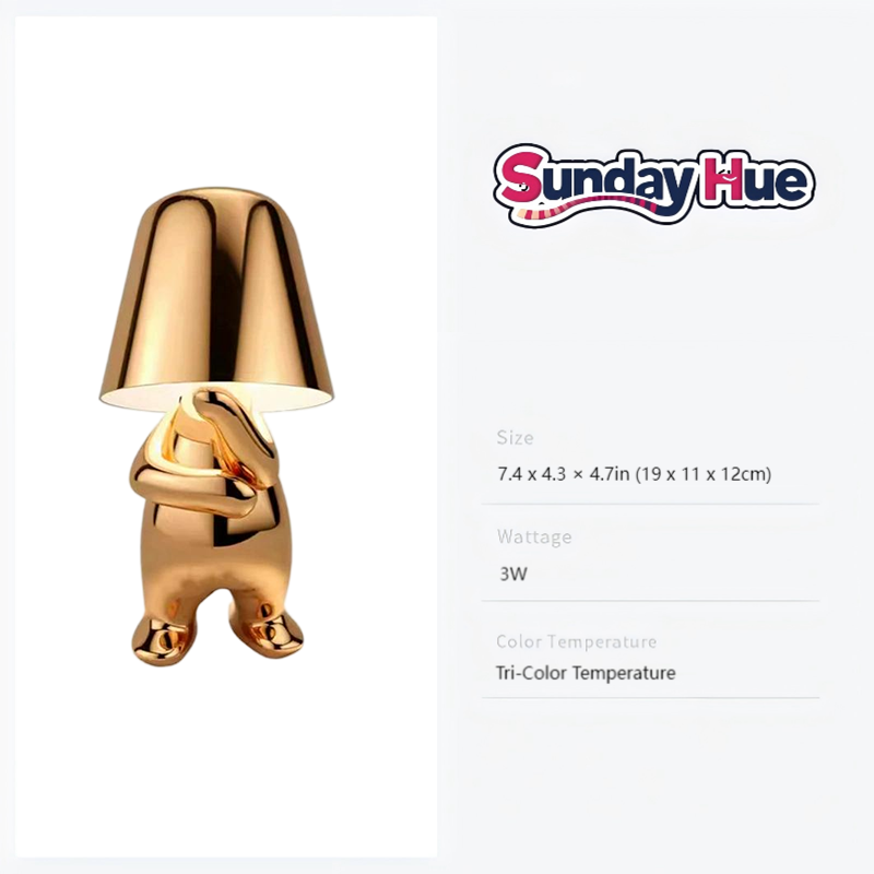 Gold Soulster Lamp with arms crossed, symbolizing deep contemplation and creative thought