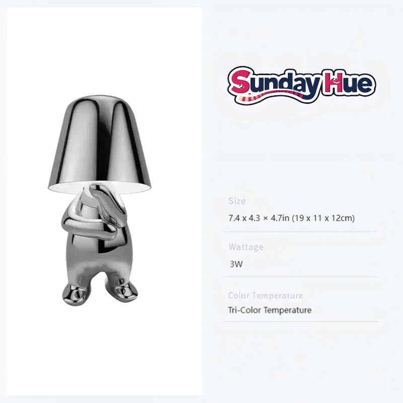 silver Soulster Lamp with arms crossed, symbolizing deep contemplation and creative thought