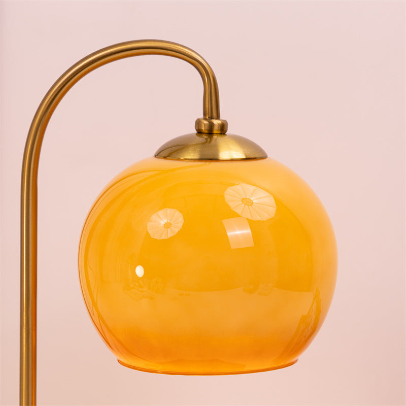 Close-up of the amber glass shade on the vintage candle warmer lamp showcasing its warm retro elegance