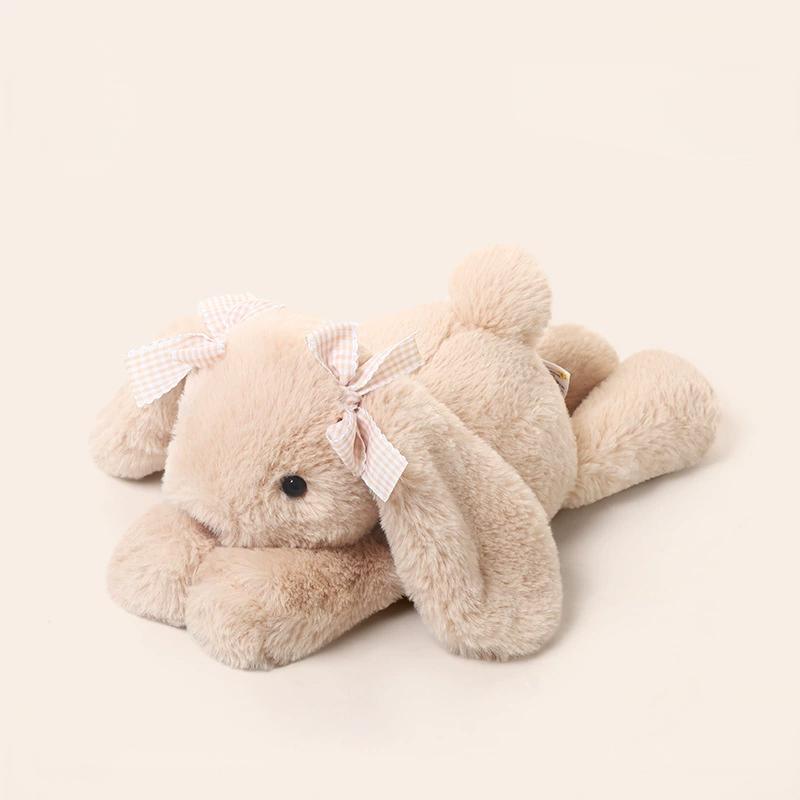 Bunny laying plush with delicate bows, bringing innocent warmth and gentle support