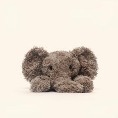  Front view of elephant laying plush toy, featuring floppy ears and ultra-soft long plush for understanding and comfort
