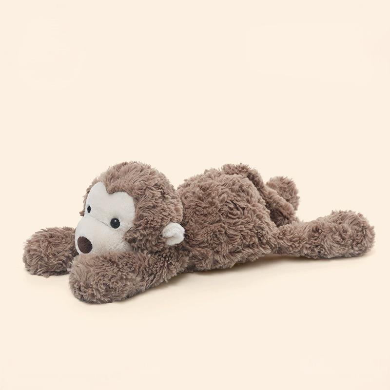Side profile of monkey laying plush, full of playful energy for interactive warmth