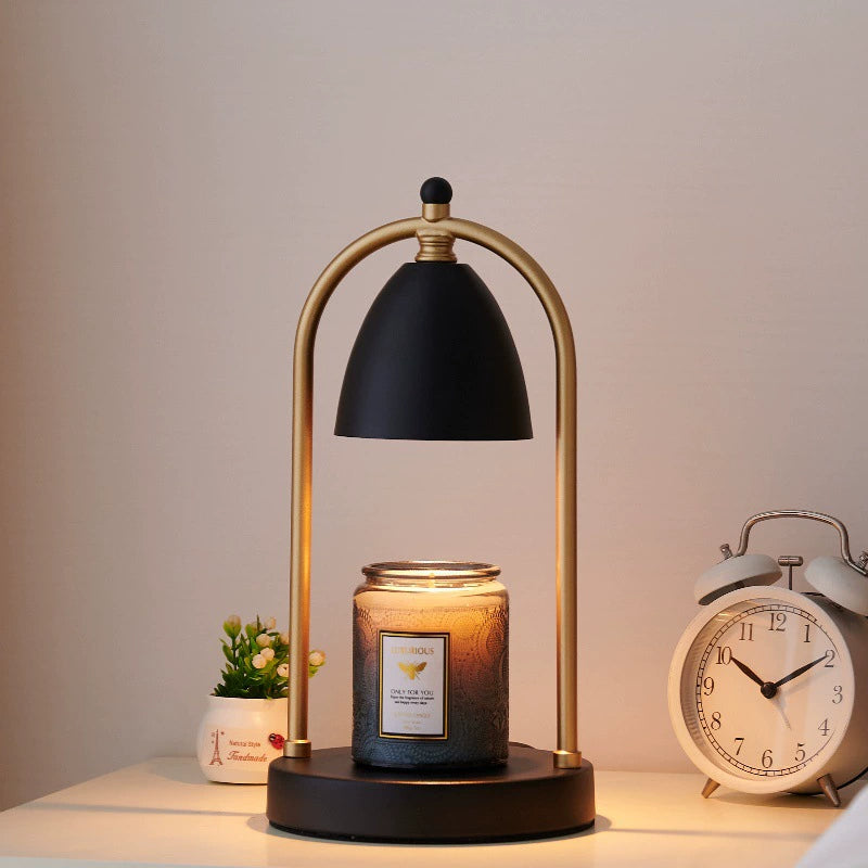 Black and gold vintage romantic candle warmer lamp with a glass candle, radiating warmth and comfort in the bedroom.