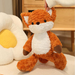 A soft Running Fox Plush Toy being gently held up, displaying its adorable face and fluffy body.