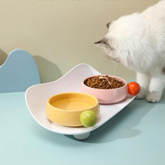Cat interacting with Sugar Bean Ceramic Cat Bowls in pink and yellow