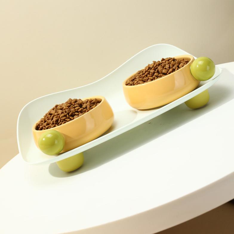 Sugar Bean Ceramic Cat Bowl with dual yellow bowls on wave tray, filled with kibble