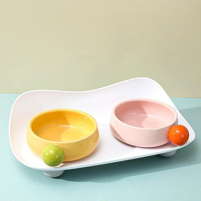 Sugar Bean Ceramic Cat Bowls in empty pink and yellow design on white tray